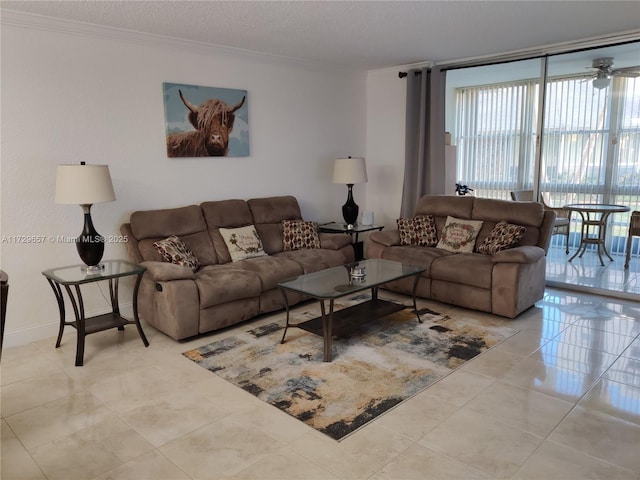 living room with a textured ceiling, ornamental molding, a wall of windows, and light tile patterned floors