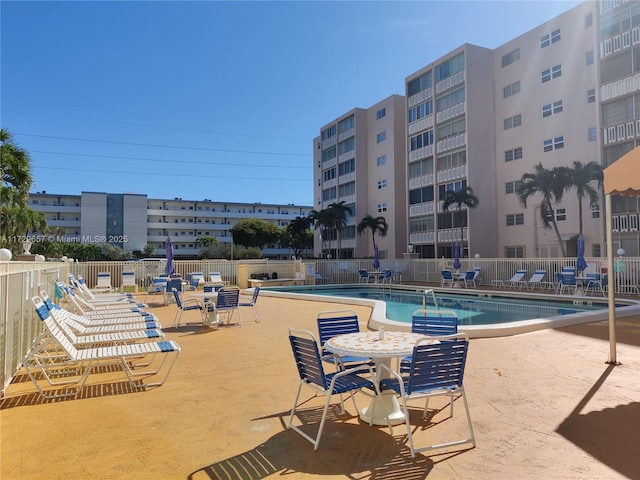 community pool featuring a patio and fence