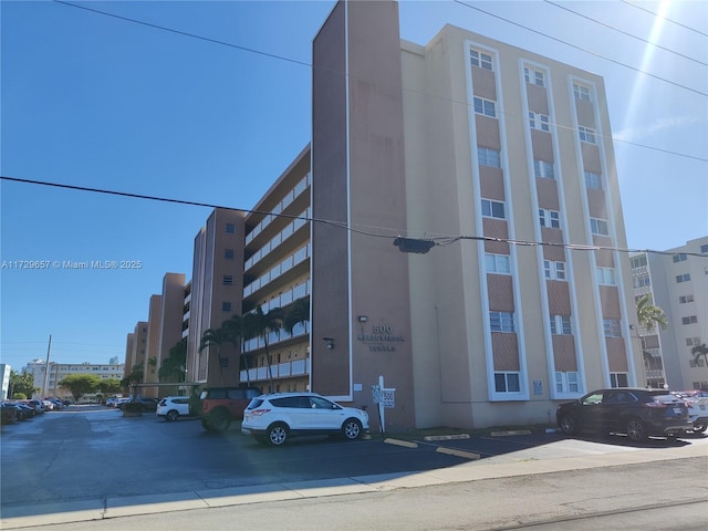 view of property featuring uncovered parking