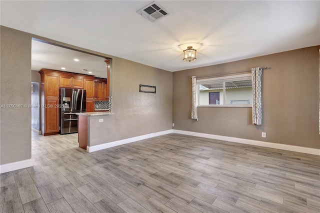 spare room featuring recessed lighting, baseboards, visible vents, and light wood finished floors