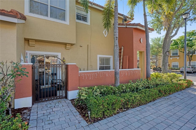 3383 Merrick Ct Unit 1116, Margate, FL 33063 - doorway to property featuring stucco siding, a gate, and a tile roof