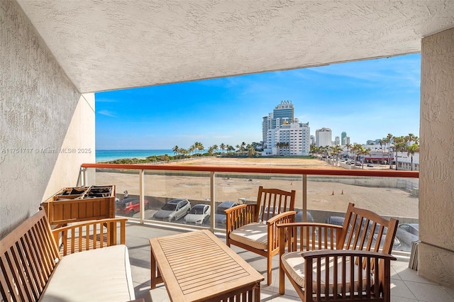 balcony featuring a view of city and a water view