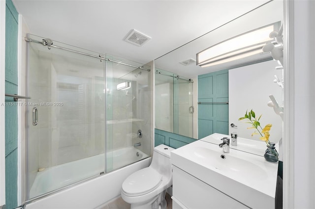 bathroom featuring toilet, shower / bath combination with glass door, vanity, and visible vents