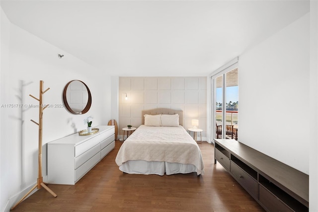 bedroom with dark wood-style floors, access to outside, and floor to ceiling windows