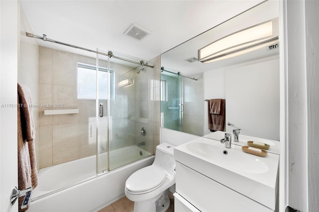 bathroom with vanity, tile patterned flooring, visible vents, toilet, and enclosed tub / shower combo