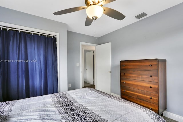 bedroom with a ceiling fan, visible vents, and baseboards