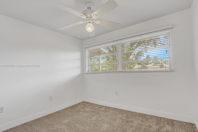 unfurnished room with carpet flooring, a ceiling fan, and baseboards