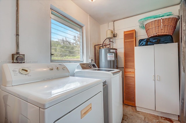 clothes washing area featuring laundry area, independent washer and dryer, and electric water heater