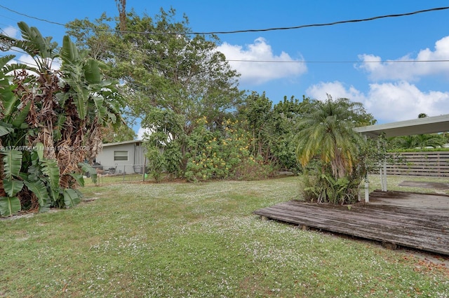 view of yard with a deck and fence