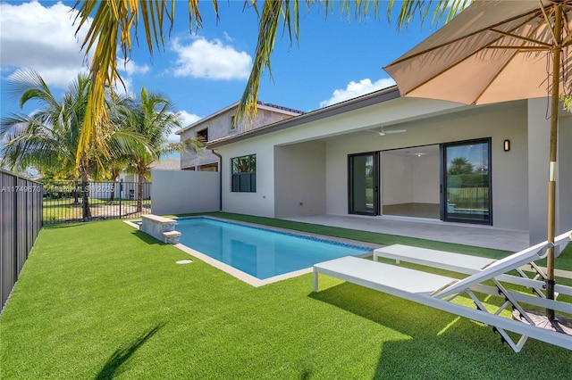 view of pool with a fenced in pool, fence, a lawn, and a patio