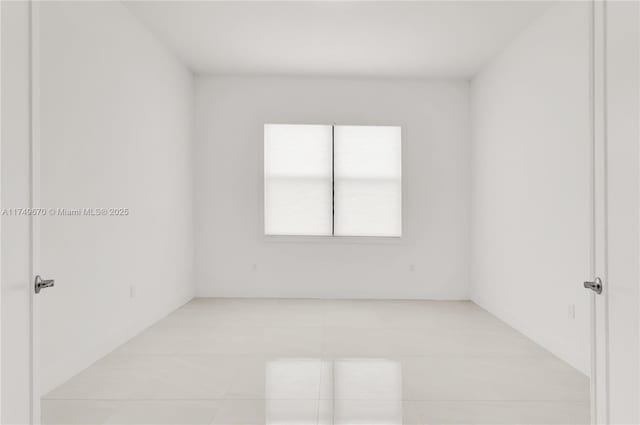 empty room with light tile patterned floors