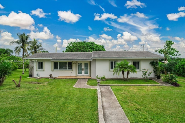 ranch-style home featuring french doors, a front yard, a tile roof, and stucco siding