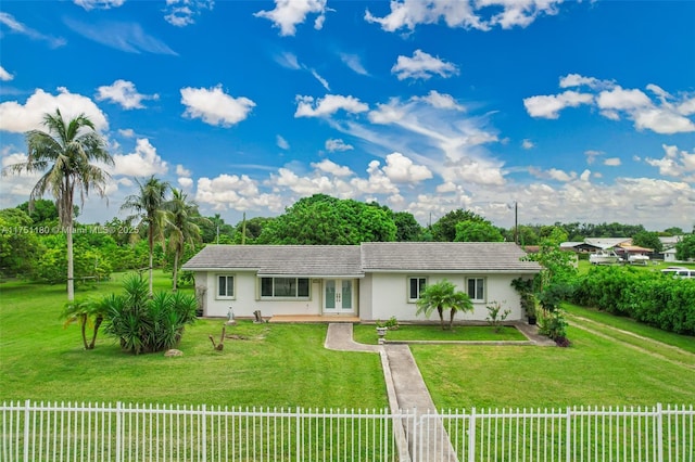 single story home with fence private yard, a tile roof, concrete driveway, french doors, and a front yard