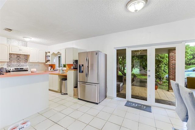 kitchen with tasteful backsplash, visible vents, appliances with stainless steel finishes, light countertops, and open shelves