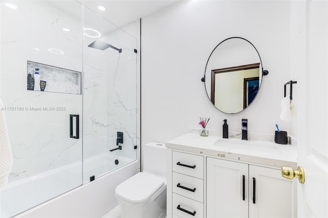 bathroom with toilet, combined bath / shower with glass door, and vanity