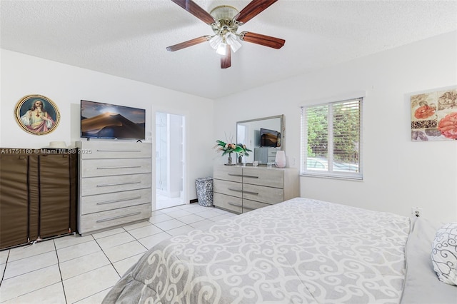 bedroom with a textured ceiling, ceiling fan, and light tile patterned flooring