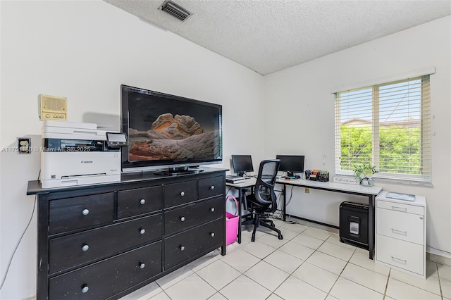 office featuring visible vents, a textured ceiling, and light tile patterned flooring