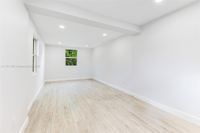 spare room featuring recessed lighting, light wood-style flooring, and baseboards