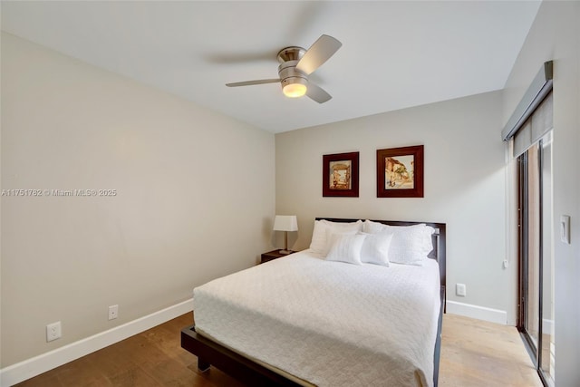 bedroom featuring light wood finished floors, baseboards, and a ceiling fan