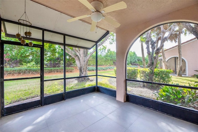 unfurnished sunroom with plenty of natural light and ceiling fan