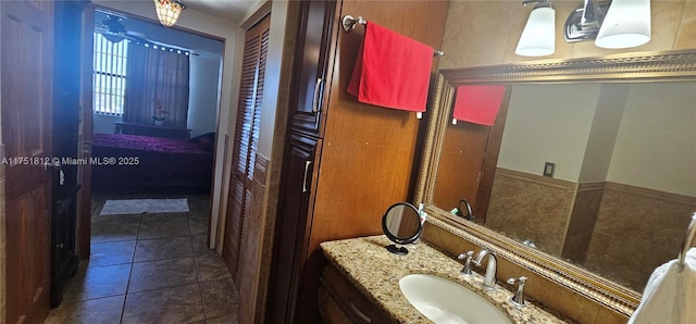 bathroom featuring tile patterned floors, connected bathroom, and vanity