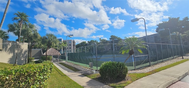 view of tennis court with fence