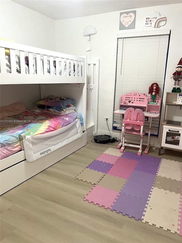 bedroom with wood finished floors