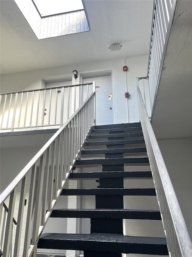 staircase with a skylight