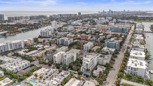 birds eye view of property with a view of city and a water view