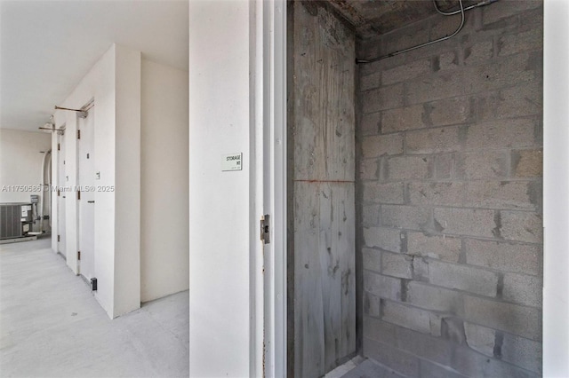 interior space featuring concrete floors and concrete block wall