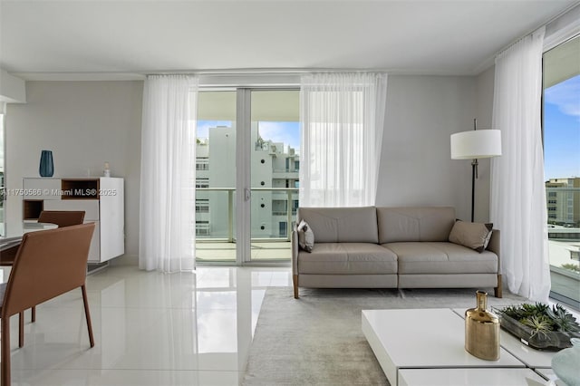 living room featuring expansive windows and light tile patterned flooring