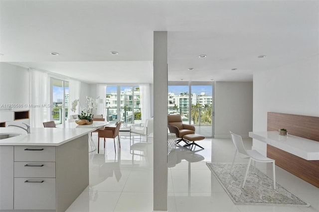 kitchen with light countertops, a wealth of natural light, modern cabinets, and white cabinetry