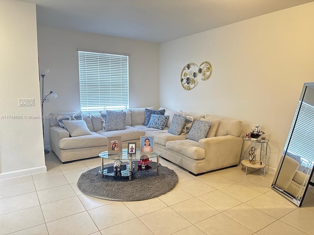 living area featuring light tile patterned flooring and baseboards