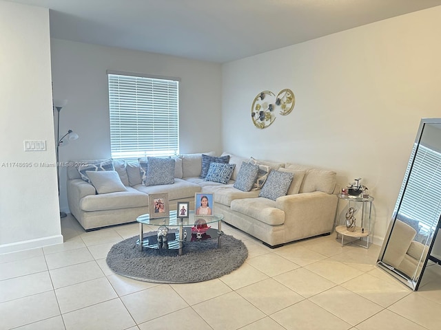 living room with light tile patterned floors and baseboards