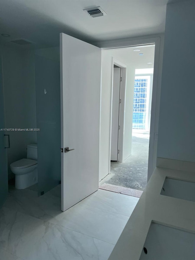 bathroom with toilet and visible vents