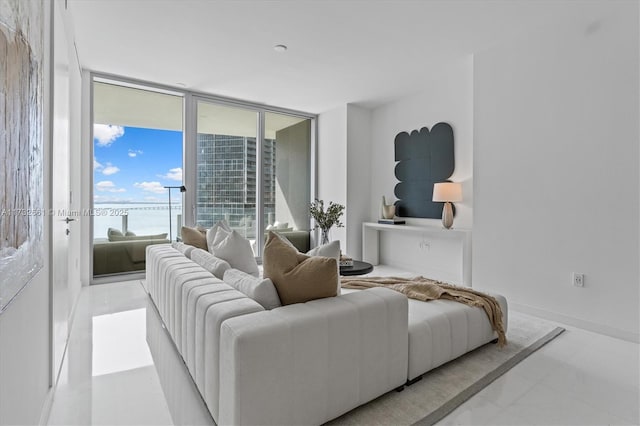 living room with expansive windows and baseboards