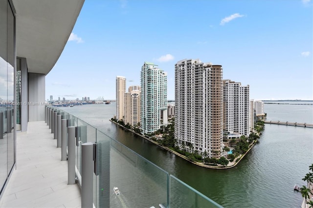 balcony with a water view and a city view