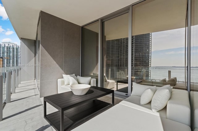 balcony with a view of city and a water view