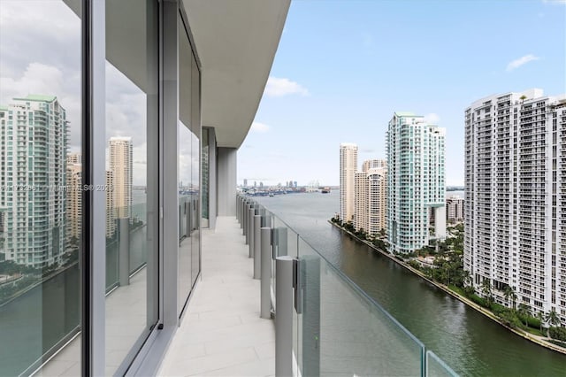 balcony with a water view and a city view