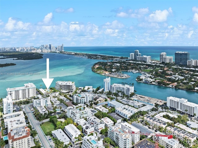 birds eye view of property with a water view and a city view