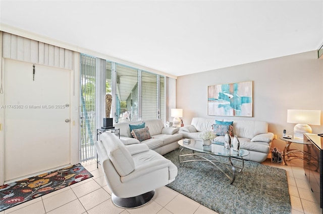 living room with floor to ceiling windows and light tile patterned floors