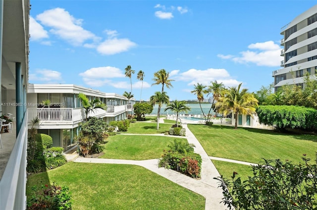 view of home's community featuring a water view and a yard