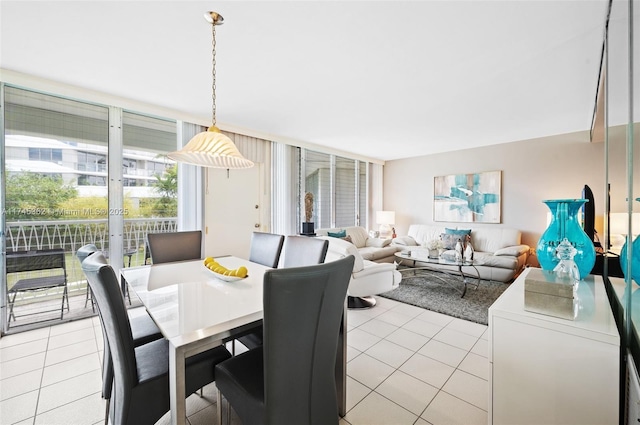 dining area featuring expansive windows and light tile patterned flooring