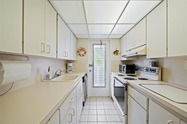 kitchen featuring under cabinet range hood, a sink, white cabinets, light countertops, and appliances with stainless steel finishes