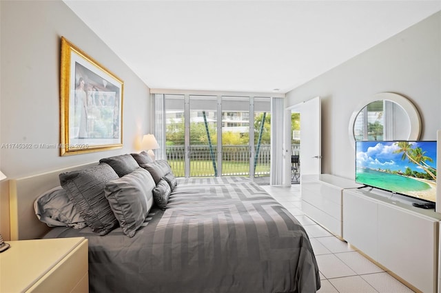 bedroom featuring light tile patterned floors, multiple windows, and access to exterior