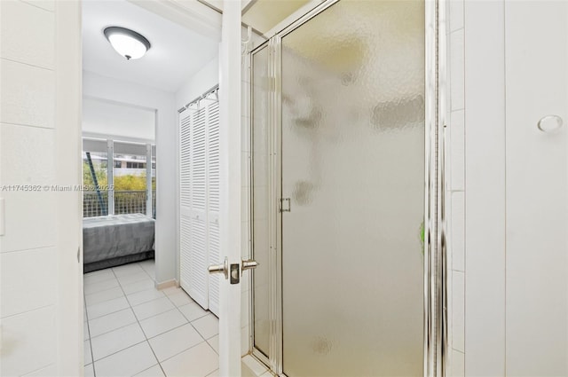 full bath featuring ensuite bath, a stall shower, tile patterned flooring, and a closet