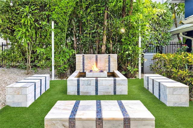 view of yard with fence and a fire pit