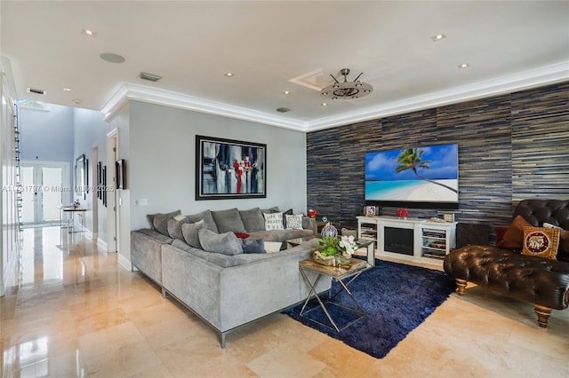 living room with an accent wall, recessed lighting, crown molding, and baseboards