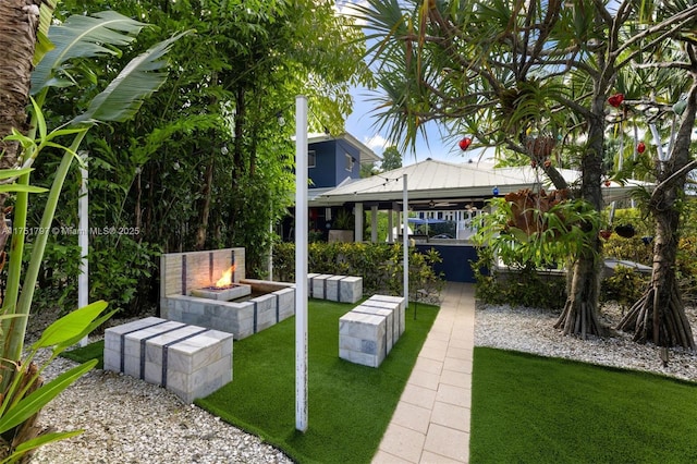 view of yard featuring an outdoor fire pit