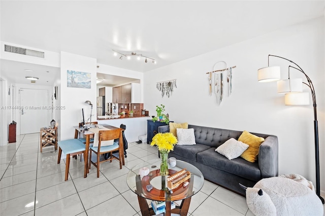 living room with light tile patterned floors and visible vents